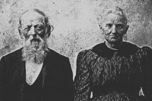 An older man with a beard and his wife