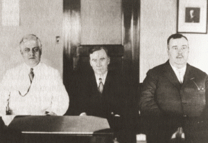 A sepia-toned photo of three men.